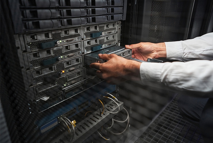 A technician working on a server in a data center